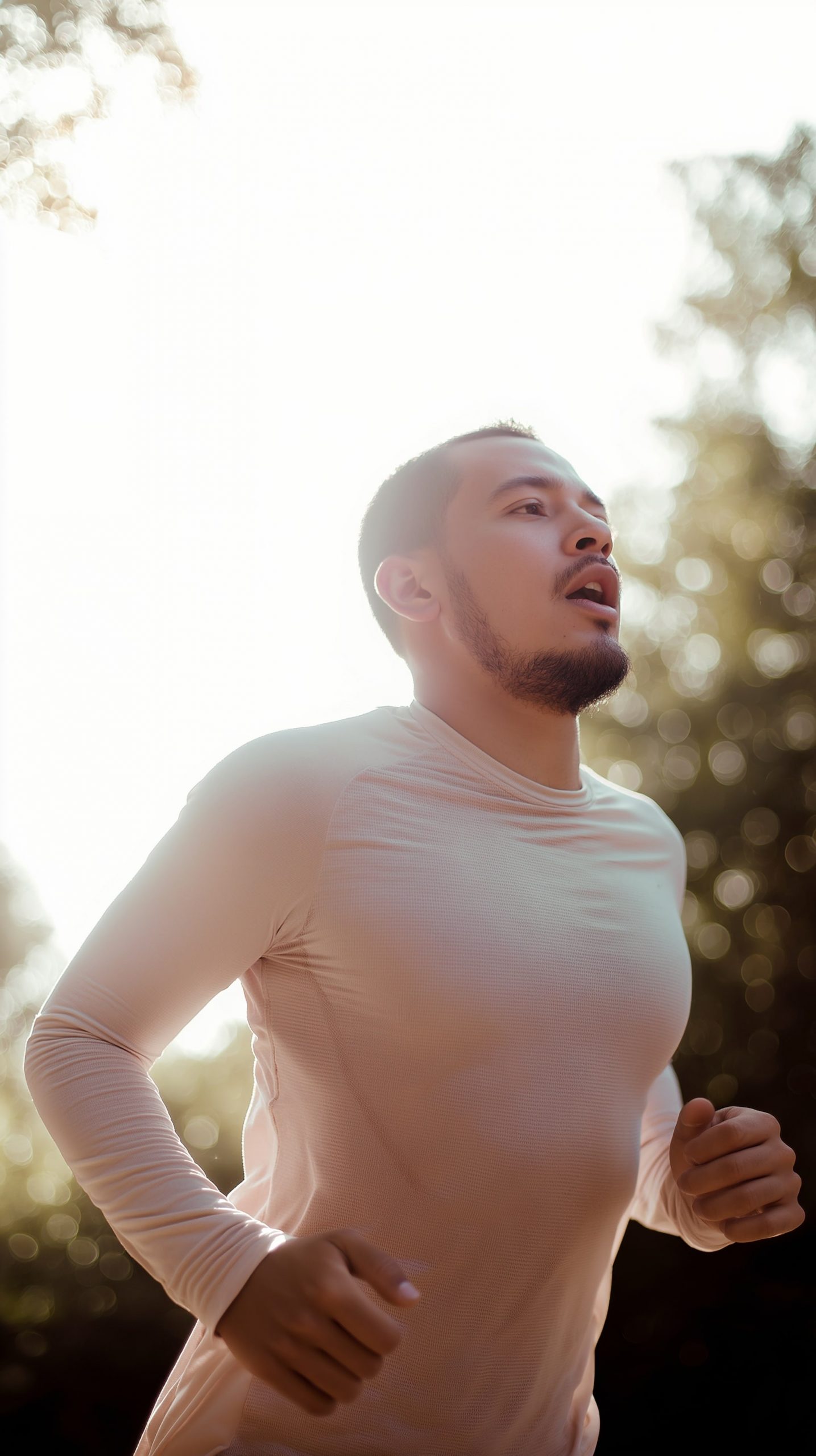 Homme courant en plein air, soleil en arrière-plan.