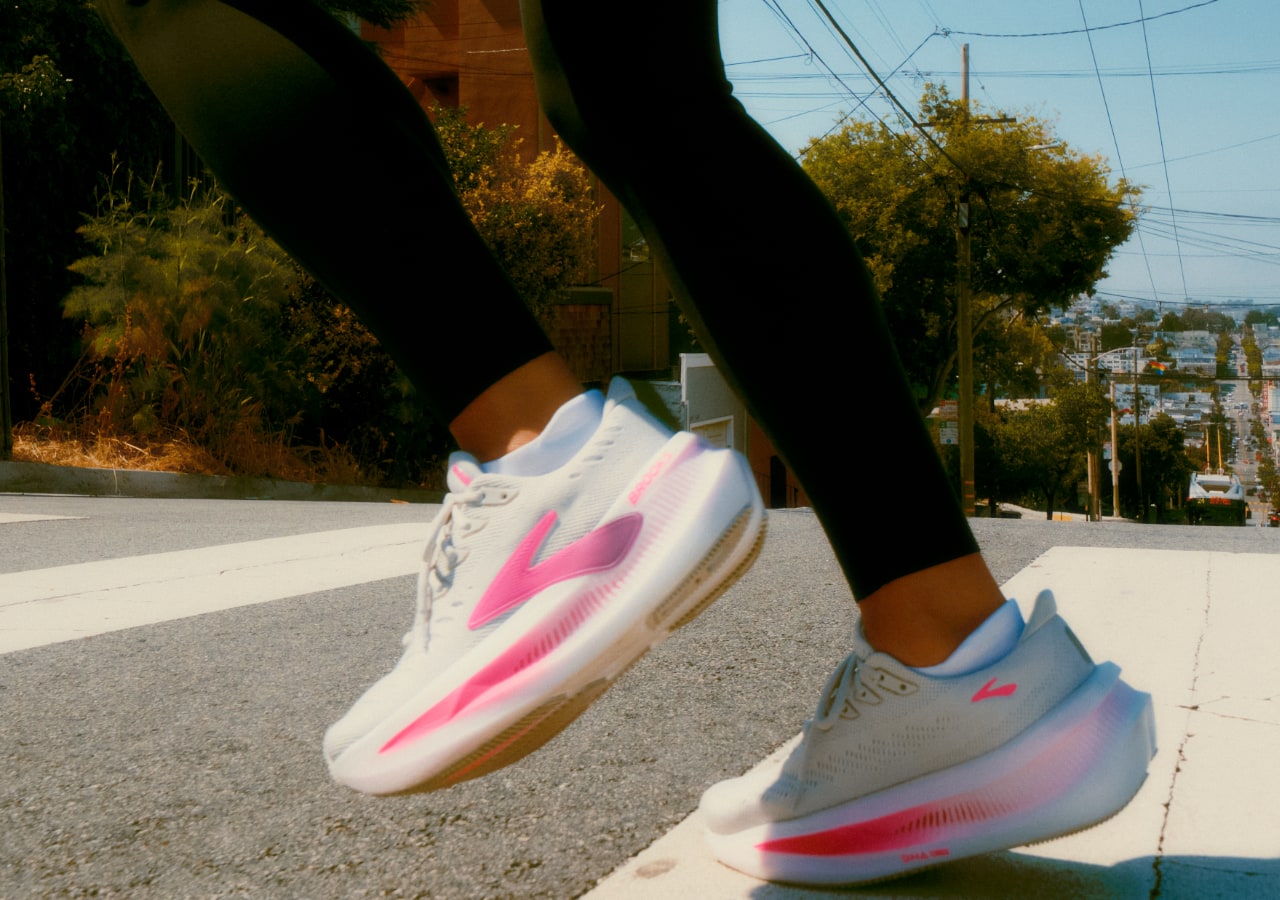 Course en montée avec des baskets blanches et roses.