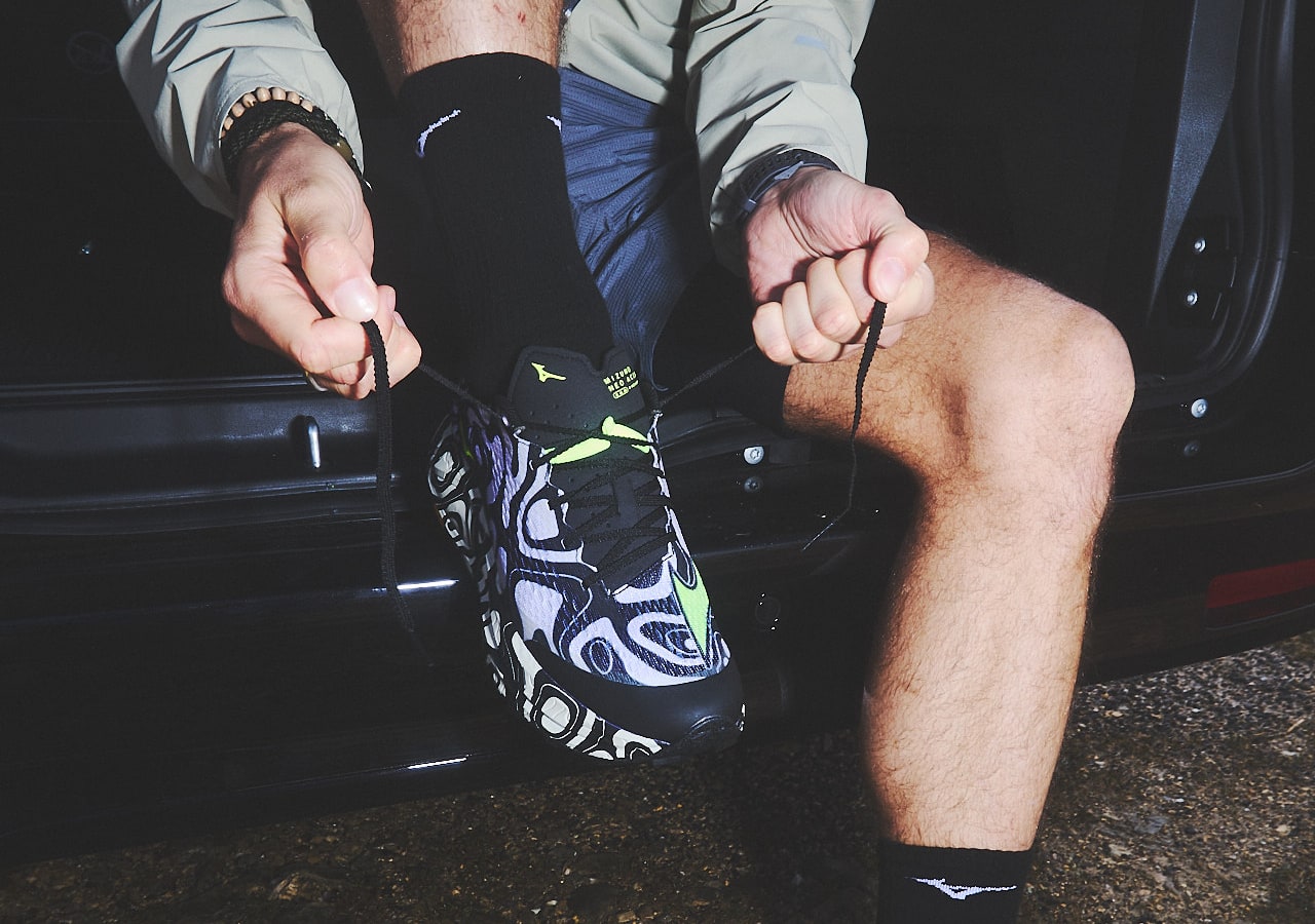 Lacing colorful running shoes in a car.