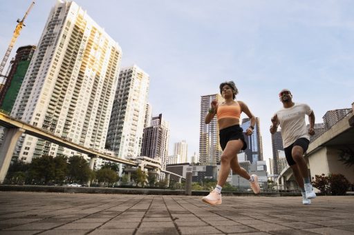 Deux coureurs en Brooks Ghost Amp sur une esplanade face aux tours de Miami